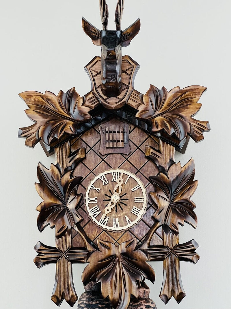 Eight Day Hunter's Cuckoo Clock with Hand-carved Maple Leaves, Rifles, and Buck