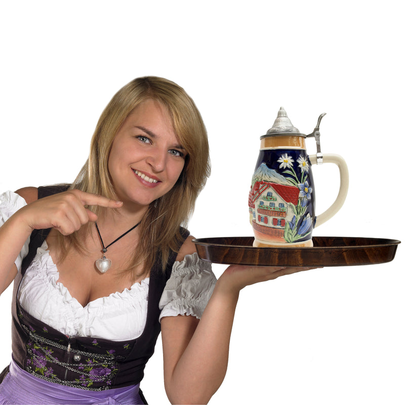 A beautiful presentation of a German Alpine scene with a Chalet and Edelweiss motifs artfully presented around this .75 Liter ceramic beer stein. This beer stein is topped off with an ornate metal lid.