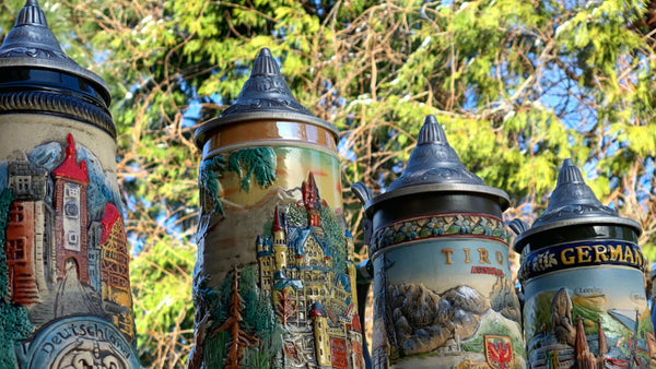 What is the purpose of the hinged lid on beer steins?