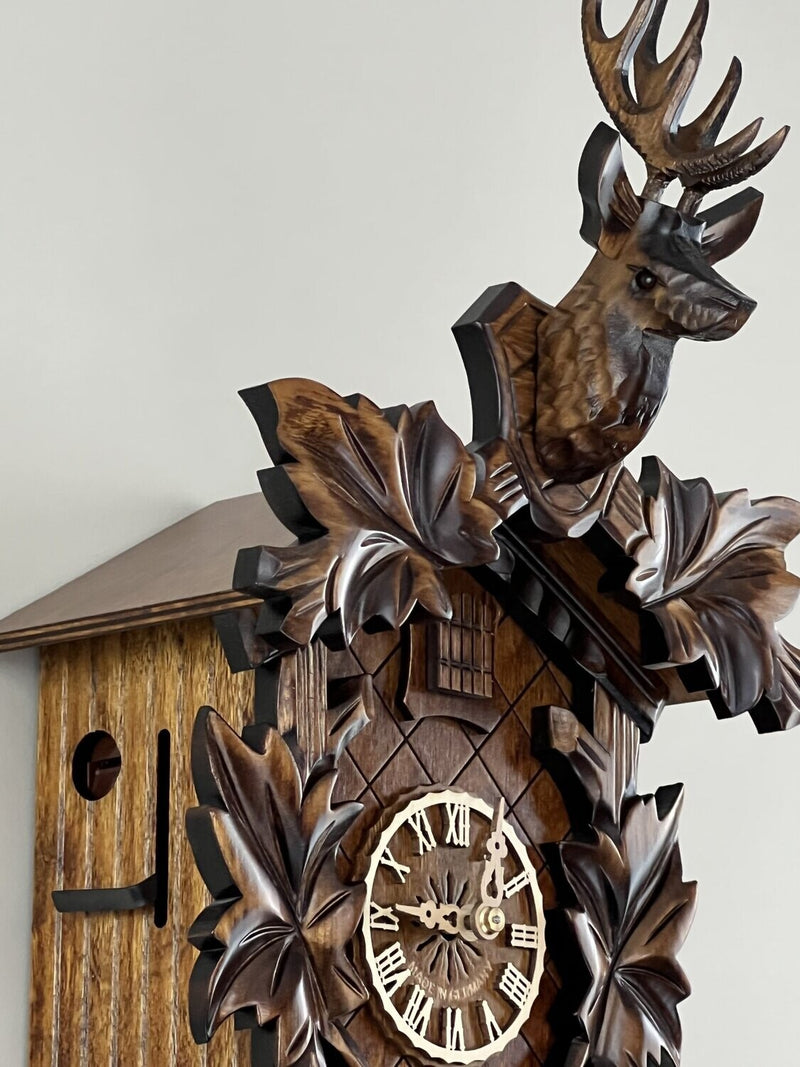 Eight Day Hunter's Cuckoo Clock with Hand-carved Maple Leaves, Rifles, and Buck