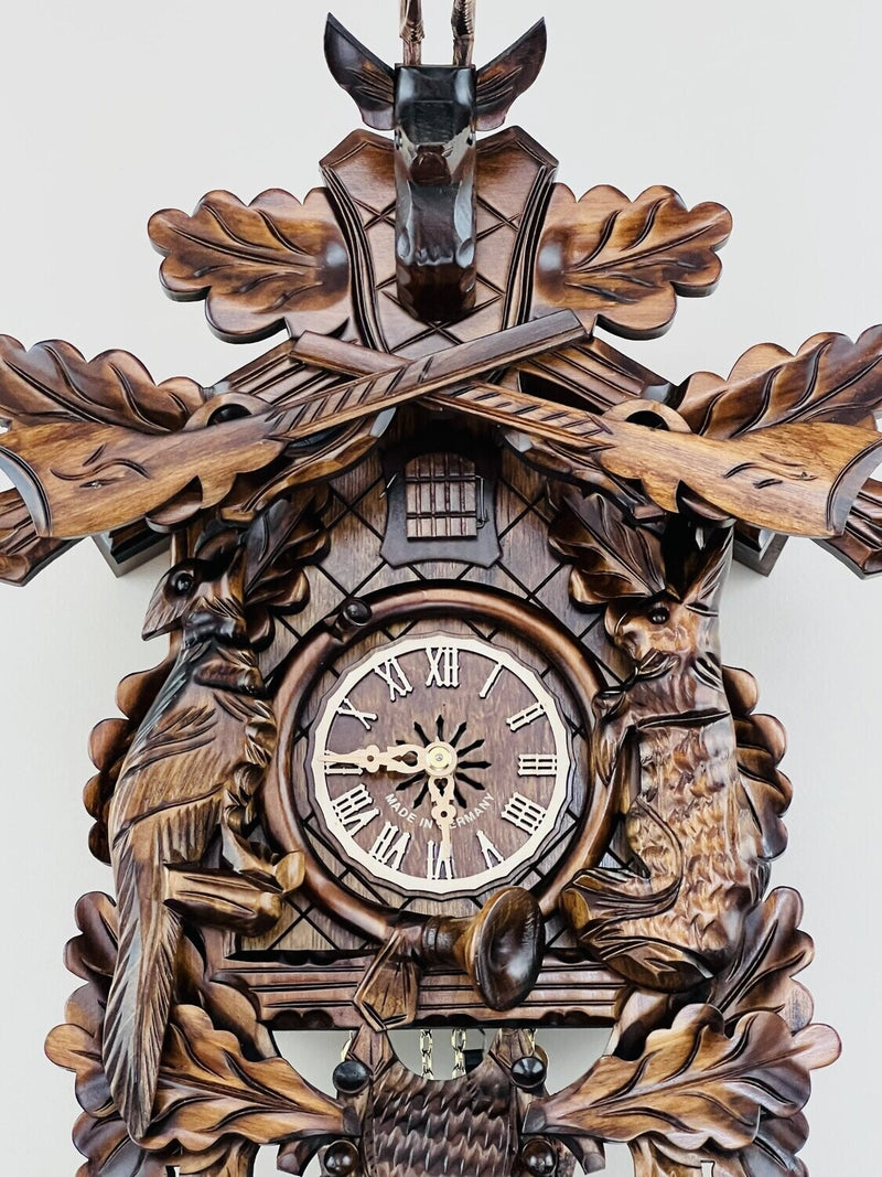 Eight Day Hunter's Cuckoo Clock with Hand-carved Oak Leaves, Animals, Rifles, and Buck
