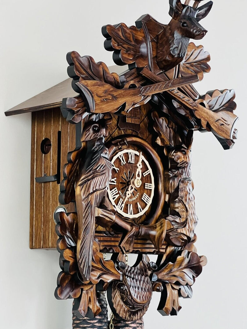 Eight Day Hunter's Cuckoo Clock with Hand-carved Oak Leaves, Animals, Rifles, and Buck