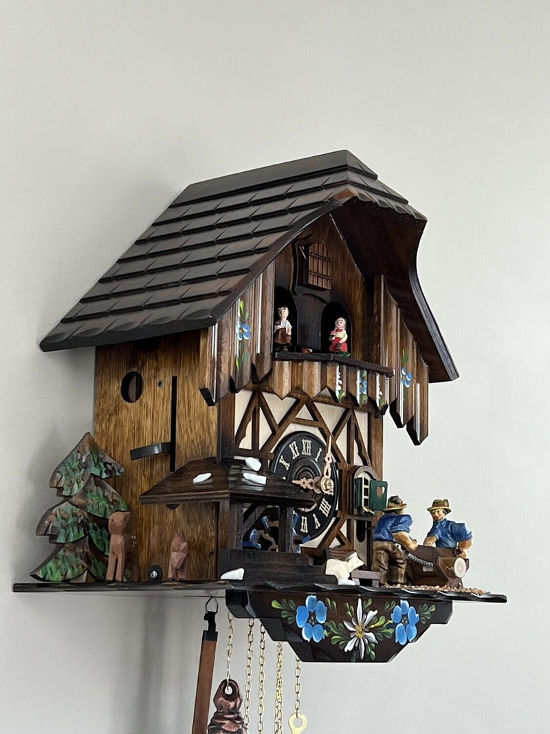 One Day Musical Cuckoo Clock with Men Sawing Wood, Waterwheel, and Dancers