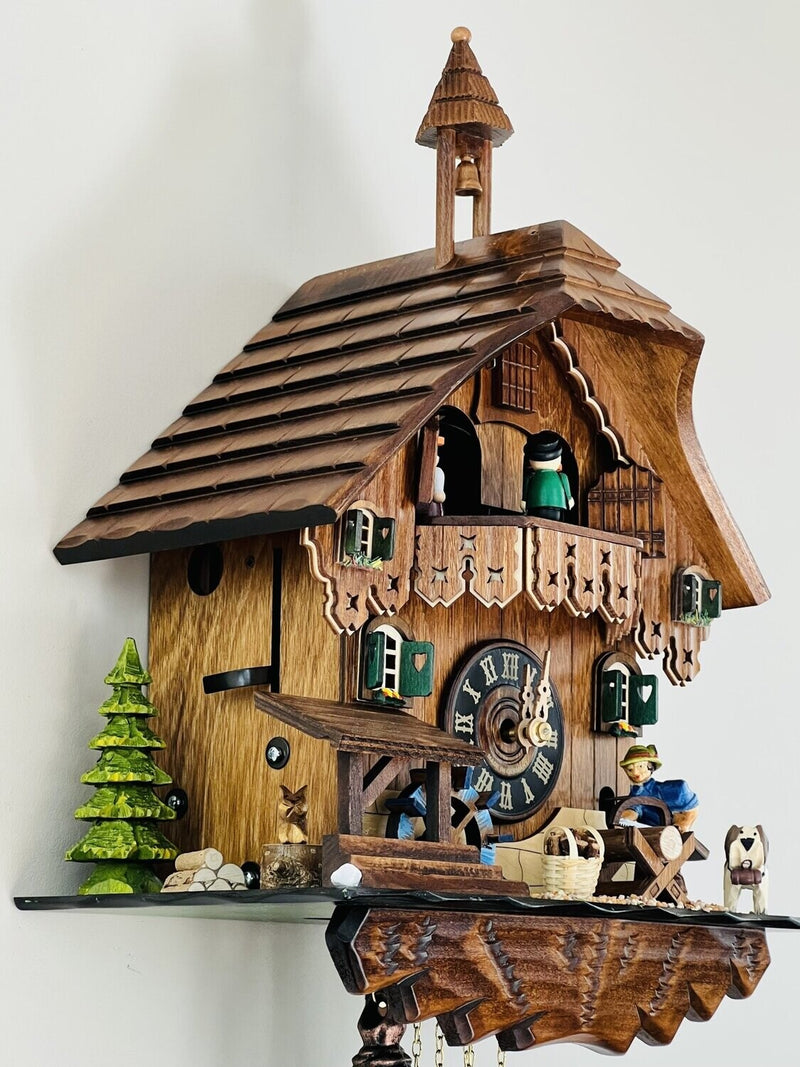 One Day Musical Cuckoo Clock Cottage with Man Sawing Wood, Waterwheel and Dancers