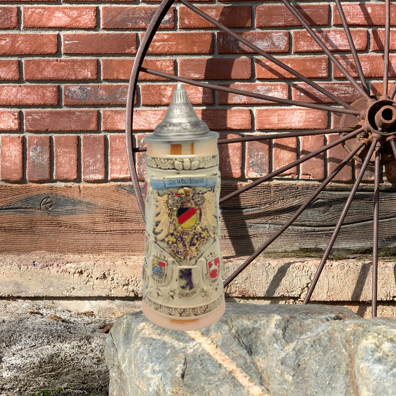 German Coat of Arms Ceramic Stein with metal lid. This decorative and colorful engraved beer stein makes for a great classic gift or decorative accent to your collection!